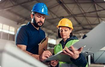 a male and female facility team working together on schedule